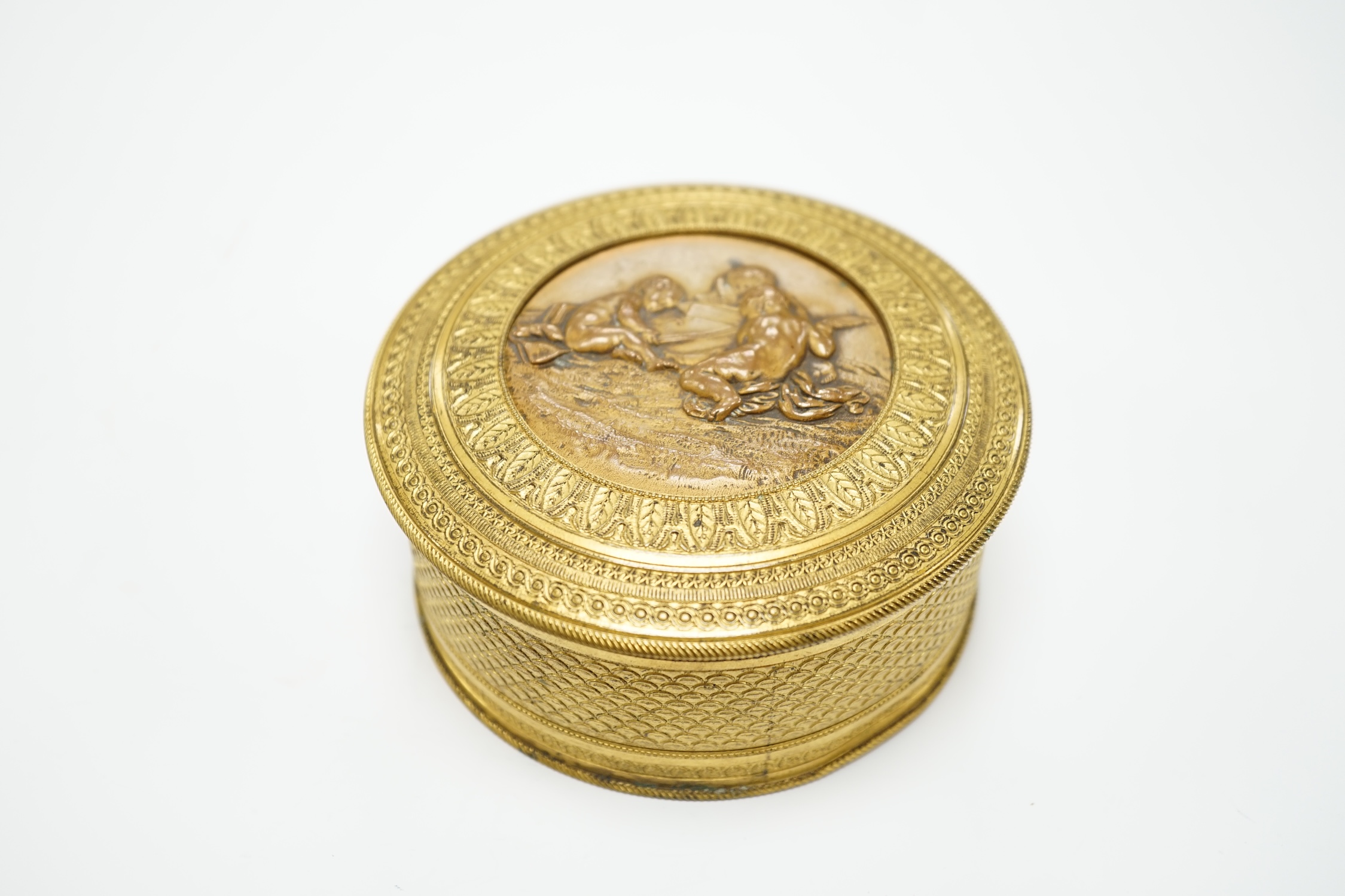 A 19th century French ormolu and bronze cylindrical box and cover with fitted mirror inside lid, 10cm diameter